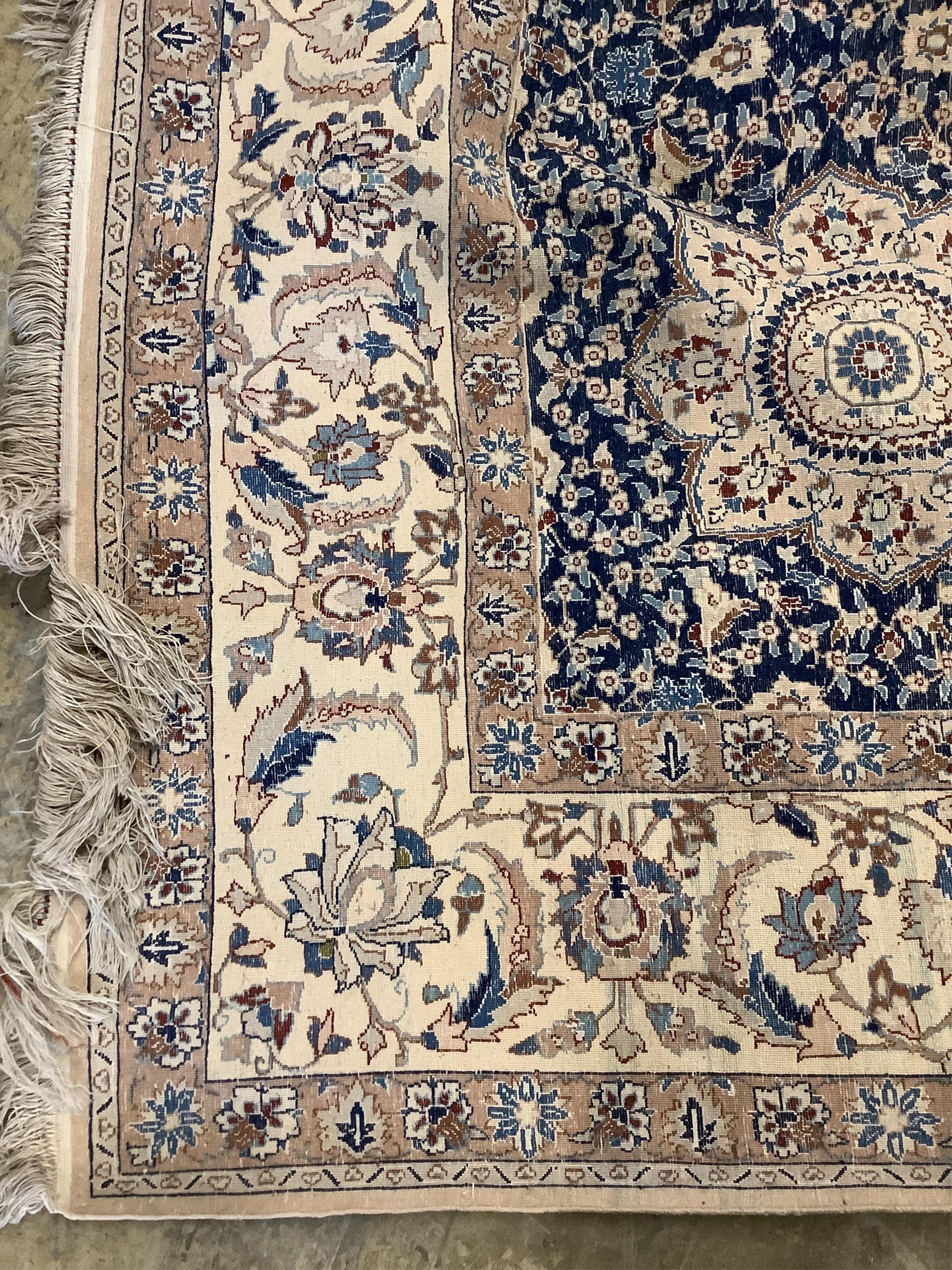 A North West Persian blue and ivory ground carpet with floral borders, 250 x 168cm. Condition - fair